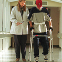 a doctor helping a patient walk.